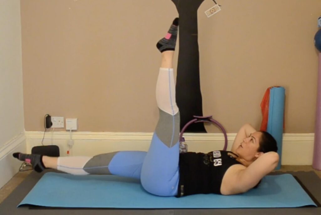 Pilates Instructor, Ceza, demonstrating the single leg circle movement.