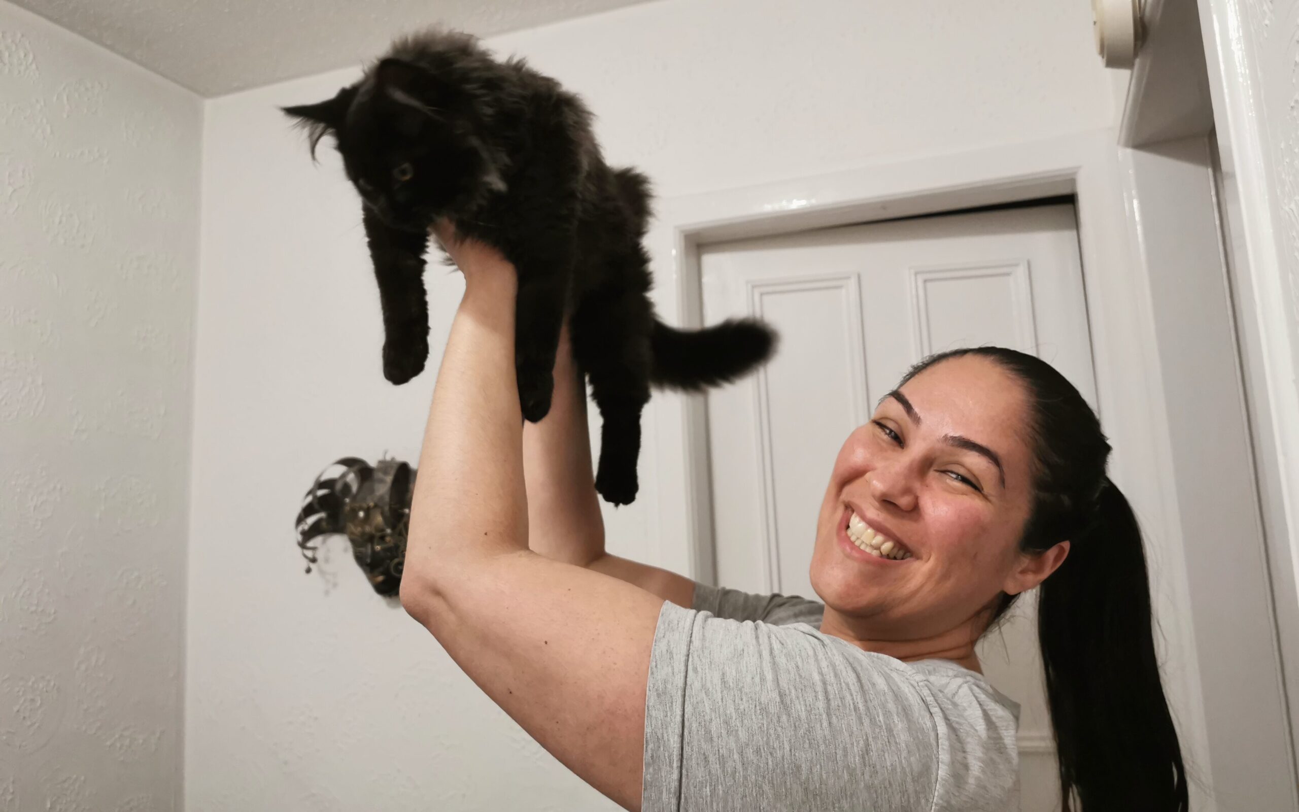 Ceza holding up her cat, Shadow, pretending to do the scene from Lion King.