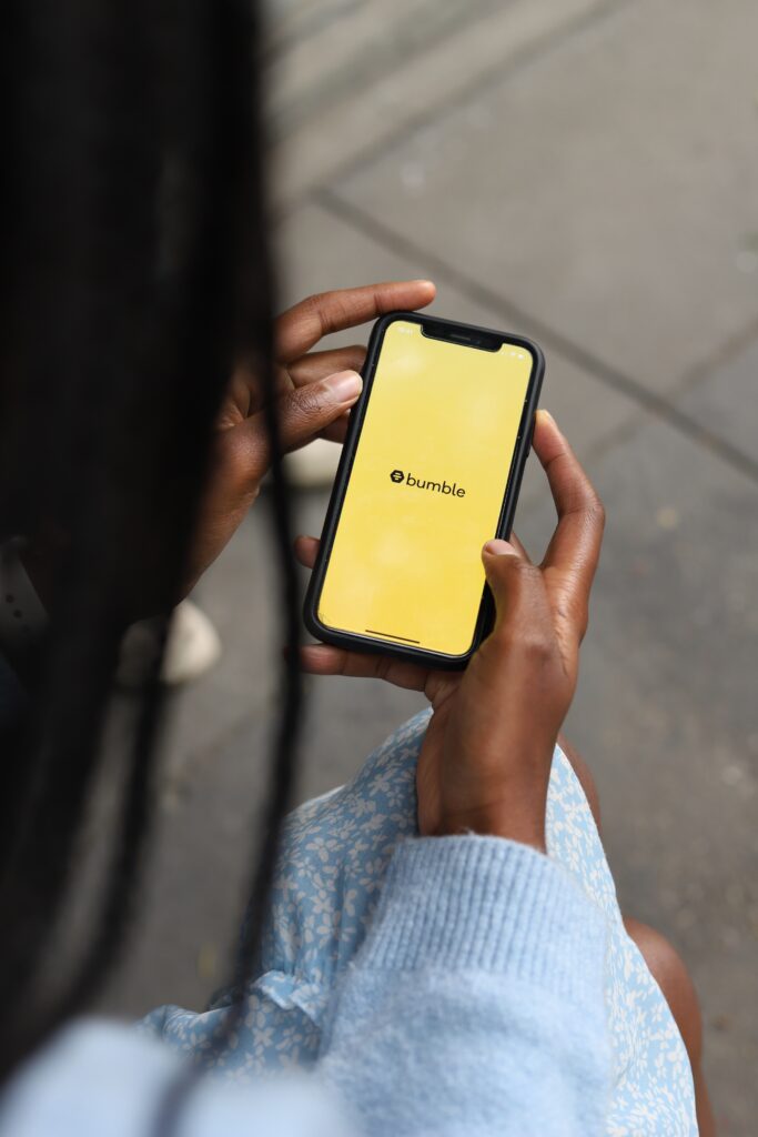 Woman on Bumble dating app, taking action after getting clear on her dream relationship. Photo by Good Faces Agency on Unsplash