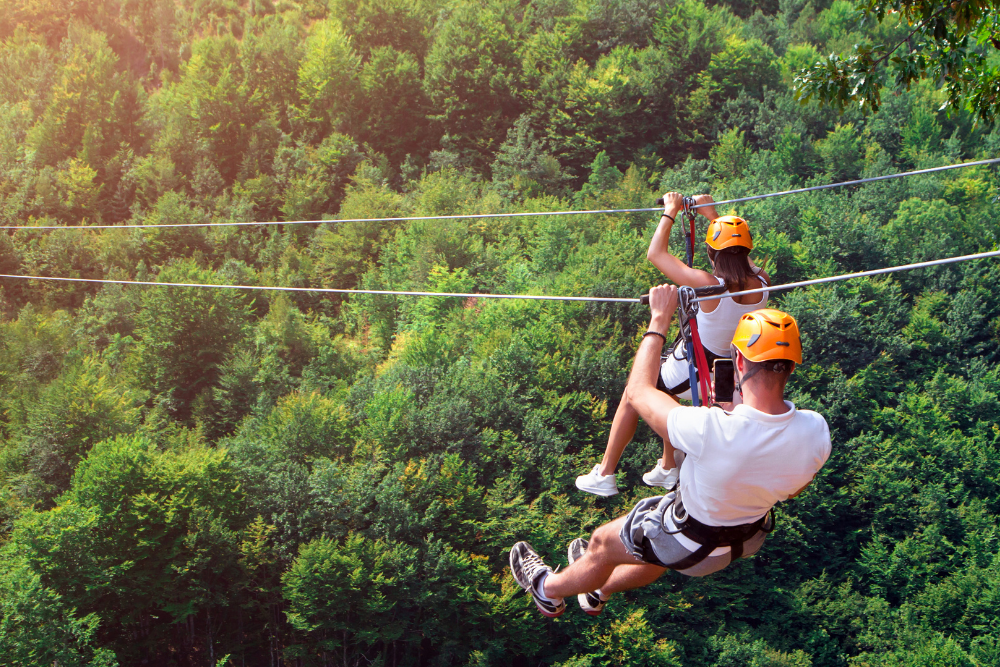 Man and woman zip lining while on a date. 